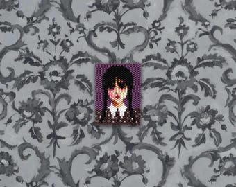 May include: A beaded portrait of a character with black hair in pigtails, wearing a white collared shirt and a dark dress. The portrait is set against a purple background and is placed on a gray floral patterned background.