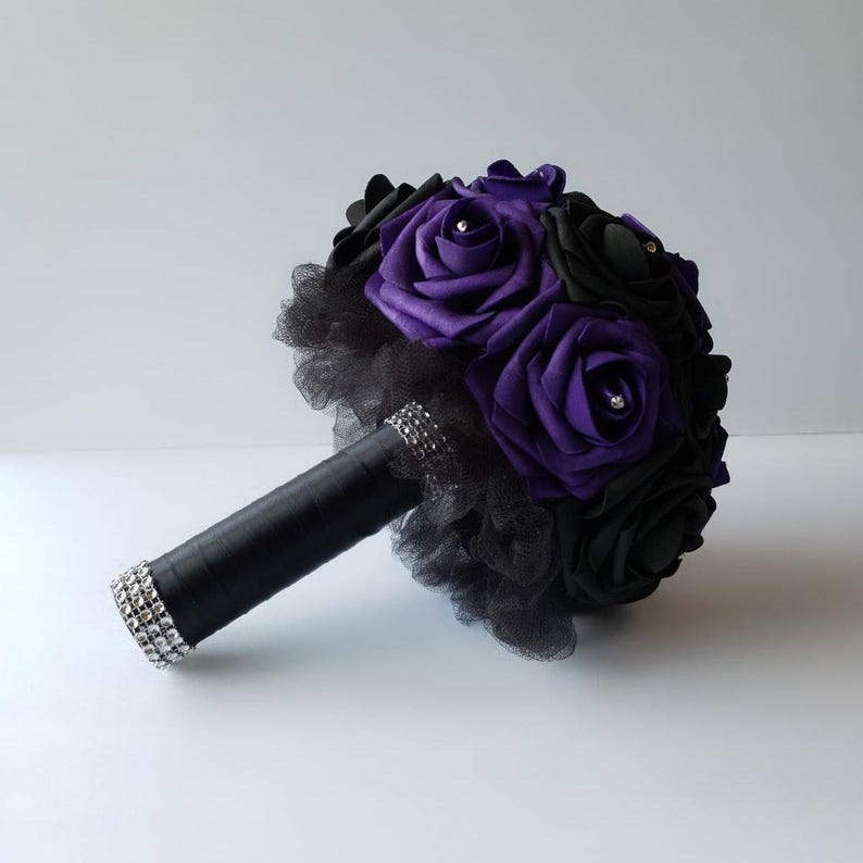 Black and dark purple rose bridal bouquet made with Real touch Roses. Black tulle and black satin ribbon on the handle. Rhinestones are on every rose.