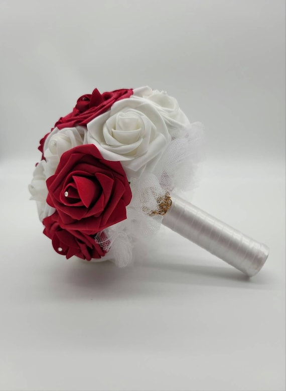 red rose bridal bouquet with diamond head pins,white ribbon and babies  breath.