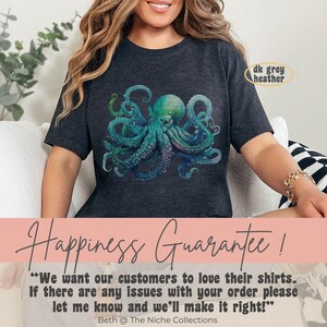 May include: A dark heather grey t-shirt featuring a colourful octopus graphic. The shirt has a crew neck and short sleeves. The text "Happiness Guarantee!" is printed below the octopus. The text "We want our customers to love their shirts. If there are any issues with your order please let me know and we'll make it right!" is printed below the guarantee text. The text "Beth @ The Niche Collections" is printed below the guarantee text.