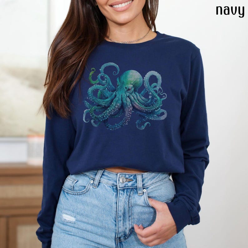 May include: A navy blue long-sleeved shirt featuring a graphic print of a blue and green octopus.