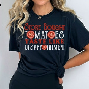 May include: Black t-shirt with red text that reads "Store Bought Tomatoes Taste Like Disappointment".