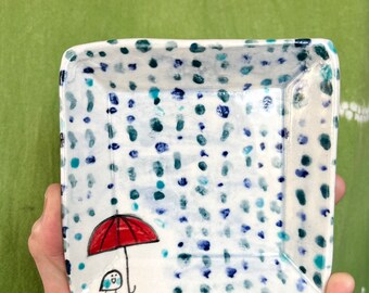 Square plate, bird and umbrella