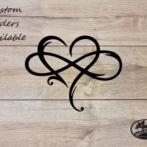 May include: Black infinity symbol design with a heart shape in the center. The design is on a wood background. The text "Custom orders available" is at the top of the image.