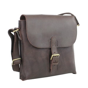 May include: A brown leather messenger bag with a buckle closure and adjustable strap.