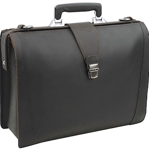 May include: A dark brown leather briefcase with a silver metal handle and clasp. The briefcase has a flap with a buckle closure.