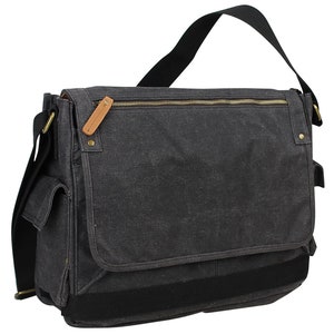 May include: A black canvas messenger bag with a zippered top closure, a large front pocket, and a black adjustable shoulder strap.