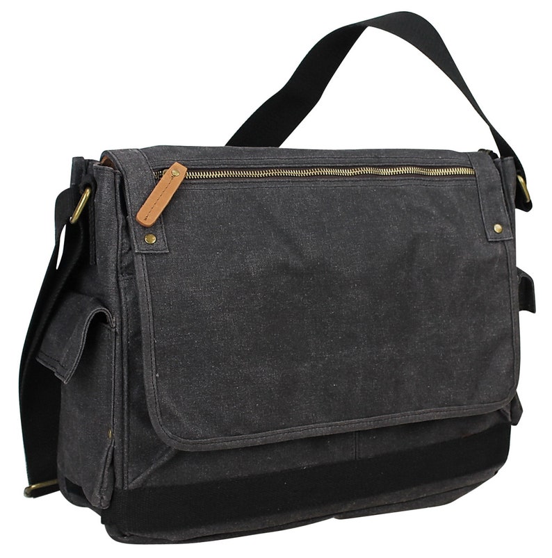 May include: A black canvas messenger bag with a zippered top closure, a large front pocket, and a black adjustable shoulder strap.