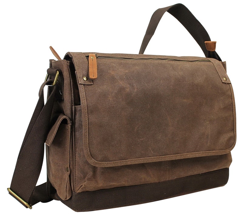 May include: A brown canvas messenger bag with a zippered closure, a flap, and a brown leather strap. The bag has a front pocket and a brown leather accent on the flap.