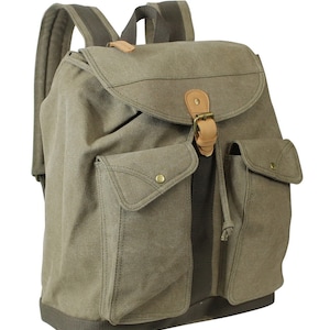 May include: A green canvas backpack with a large front pocket and a leather buckle closure. The backpack has a drawstring closure at the top and adjustable straps.