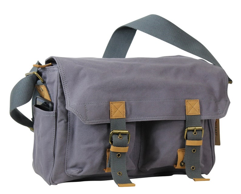 May include: A gray canvas messenger bag with brown leather accents and two adjustable buckles. The bag has a front pocket and a zippered closure.