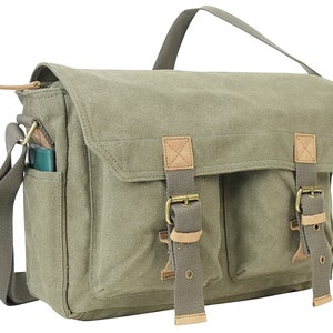 May include: A green canvas messenger bag with brown leather accents and two adjustable straps with buckles. The bag has a zippered closure and a front pocket.