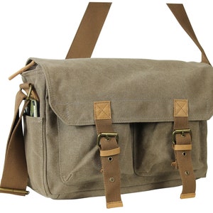 May include: A brown canvas messenger bag with two large front pockets and brown leather straps and buckles.