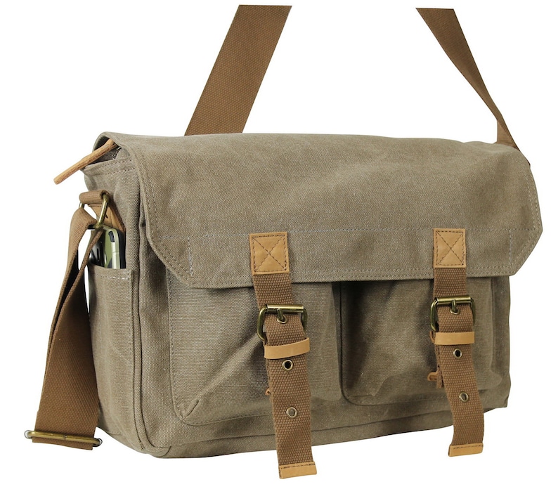 May include: A brown canvas messenger bag with two large front pockets and brown leather straps and buckles.