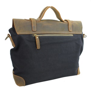 May include: A black canvas and brown leather messenger bag with a zippered pocket on the front. The bag has a top handle and a shoulder strap.