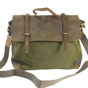 May include: A green canvas messenger bag with a brown leather flap and straps. The bag has a long adjustable shoulder strap.