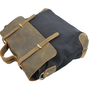 May include: A brown leather and black canvas messenger bag with a flap closure and adjustable strap.