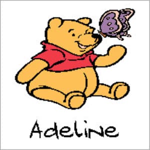 May include: A cartoon illustration of Winnie the Pooh, a yellow bear, sitting with a purple butterfly on his nose. The text "Adeline" is written below the image.