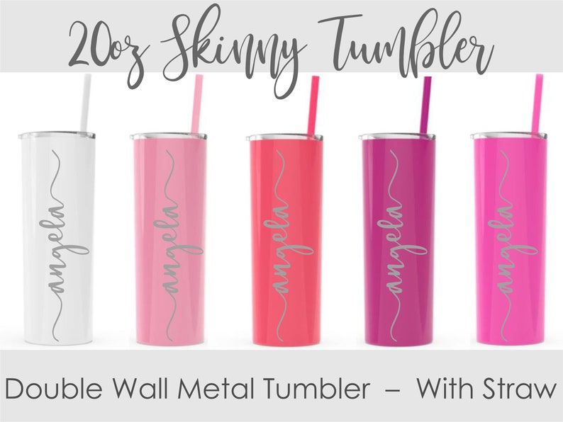 May include: A collection of five 20 oz. skinny metal tumblers in white, pink, coral, magenta, and fuchsia. Each tumbler has a matching straw and the name "angela" in a cursive font. The text "Double Wall Metal Tumbler - With Straw" is also present.