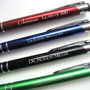 May include: Four personalized pens with silver accents. The pens are red, blue, black, and green. The text on the pens reads "Brianna Class of 2017", "The Future Mrs. Clark", "Dr. Jackson Miller", and "Your Business Name".
