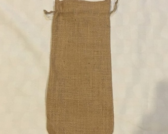 May include: A brown burlap drawstring bag. The bag is made of natural fibers and has a rustic look.