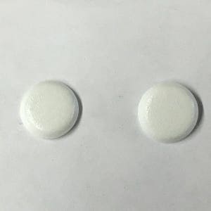 May include: Two white round buttons with a slightly textured surface.