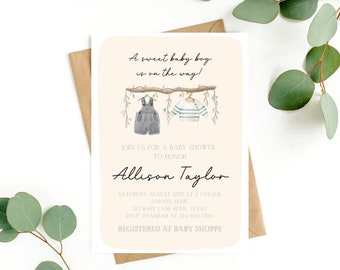 May include: A baby shower invitation with a watercolor illustration of a branch with a pair of overalls and a striped shirt hanging from it. The text reads "A sweet baby boy is on the way!" and "Join us for a baby shower to honor Allison Taylor".