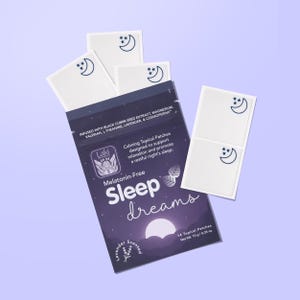 May include: A package of "Sleep Dreams" topical patches, lavender-scented, designed to support relaxation and promote sleep. The package is dark purple with white text and graphics, including a moon and stars. Several white patches with a moon and stars are visible.