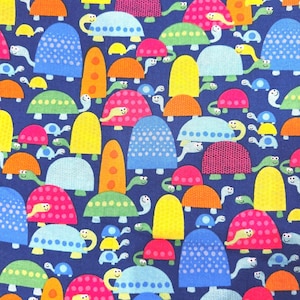 May include: A fabric pattern featuring a repeating design of colorful turtles on a dark blue background. The turtles have various shell colors, including pink, blue, yellow, and orange, with smiling faces.