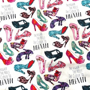 May include: A white background is covered with illustrations of high-heeled shoes in various colors and patterns, including leopard print, floral, and solid colors. The text "THE HIGHER THE HEELS THE CLOSER TO HEAVEN" is repeated throughout the design.