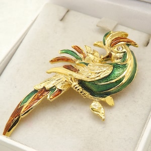 A superb exotic/bird of paradise costume jewelry brooch in goldtone metal decorated in mixed coloured enamel set with clear white stone