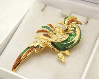 A superb exotic/bird of paradise costume jewelry brooch in goldtone metal decorated in mixed coloured enamel set with clear white stone