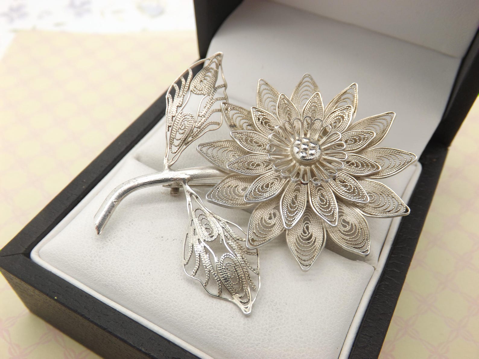 Silver filigree flower brooch