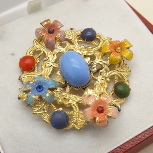 A superb early Czech round shape mixed flower brooch in filigree goldtone metal and enamel and set with mixed colour stones
