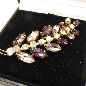 A fine Austrian made large flower spray design vintage jewelry brooch in goldtone metal set with sparkly mixed coloured faceted stones