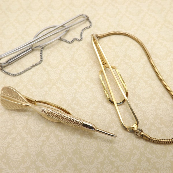 A superb group of three vintage Stratton England unisex tie clips made in silvertone and goldtone metal in different designs