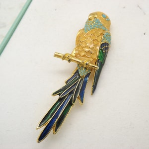 A fine early large parrot sitting on a branch vintage jewelry brooch in goldtone metal and coloured enamel and set with turquoise stones