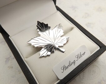 A lovely Ladye Fayre Canada Sterling silver maple leaf vintage jewelry brooch made in engraved and polished shiny silver.