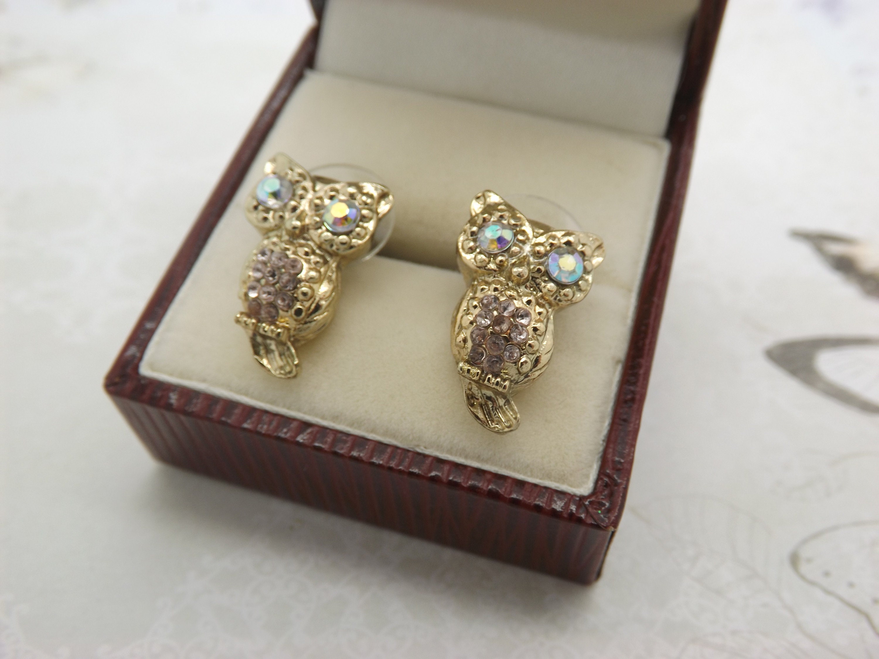 A super fun pair of sitting owl costume jewelry pierced earrings made in shiny goldtone  metal set w