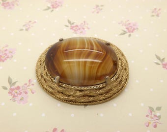 A fine large oval 1960's / 70's ' Sphinx ' vintage jewelry brooch in a woven rope goldtone mount set with a striped cream to brown stone
