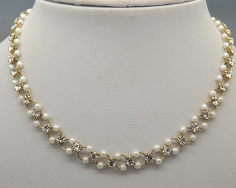 A lovely mixed design of faux pale cram pearls and clear round sparkly faceted diamante stones held together on a goldtone mount chain