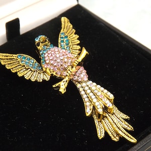 A superb large exotic tropical bird or parrot costume jewelry brooch in goldtone metal with black enamel set with mixed coloured stones