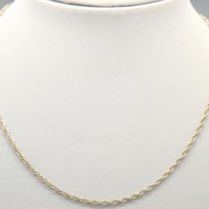 May include: A silver rope chain necklace. The chain is made of a twisted rope design.