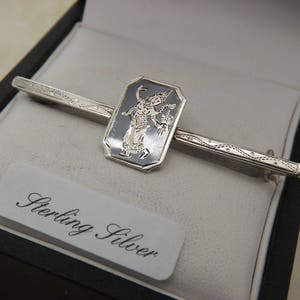 A fine early period classic Siam / Thai dancer bar design vintage jewelry brooch made in silver and black enamel