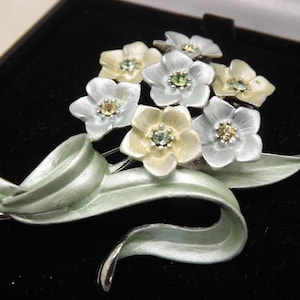 A superb flower and leaf spray modern design costume jewelry brooch in silvertone metal, soft coloured enamels and sparkly clear stones