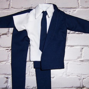May include: A navy blue suit with a white collared shirt and a black tie. The suit includes a jacket, pants, and a shirt.