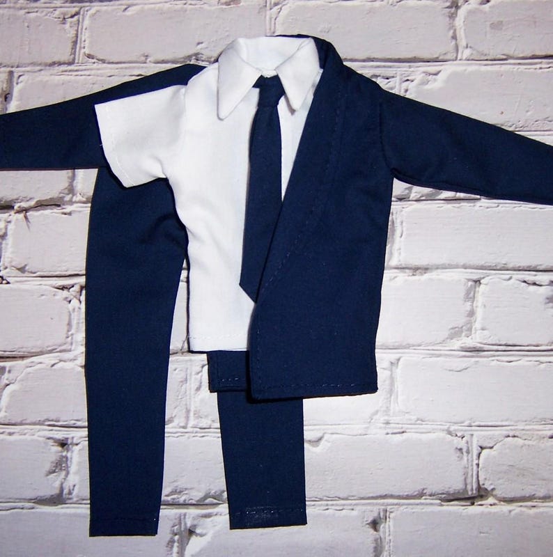 May include: A navy blue suit with a white collared shirt and a black tie. The suit includes a jacket, pants, and a shirt.