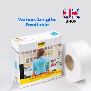 May include: A white roll of iron-on hemming tape with the brand name "Vlieseline" and the text "KANTENFIX EDGEFIX" on the packaging. The packaging also shows a person wearing a shirt with the tape applied to the hem.
