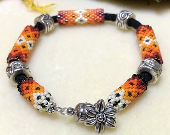 Flame - Hand braided black bamboo kumihimo with oranges and silver Japanese beaded beads and Tibetan-style metal beads