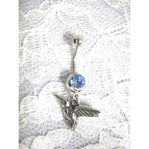 May include: Silver belly button ring with a blue gem and a hummingbird charm.